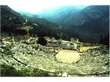 Delphi- Theatre (foreground), Temple of Apollo (centre). From her seat in the temple the oracle of Delphi gave out Apollo`s responses to questions brought by pilgrims. In the distance on the left is the school complex (gymnasium).